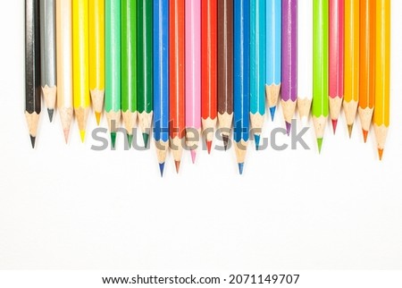 Crayons on white background, bright colors, and color pencil on top view concept for text, art, copy space.