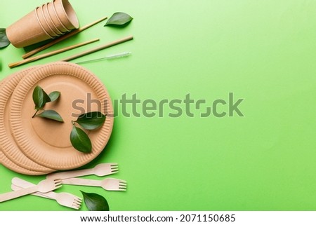set of empty reusable disposable eco-friendly plates, cups, utensils on light white colored table background. top view. Biodegradable craft dishes. Recycling concept. Close-up. Royalty-Free Stock Photo #2071150685