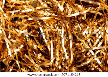 Soft focus, golden spirals tinsel. serpentine, background, blur. holiday new year 2022.  Royalty-Free Stock Photo #2071154315