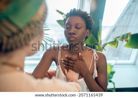 A healer working with a dark-skinned woman Royalty-Free Stock Photo #2071165439