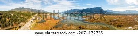 Aerial panoramic view of a scenic highway around mountains. East Kootenay, British Columbia, Canada. Royalty-Free Stock Photo #2071172735