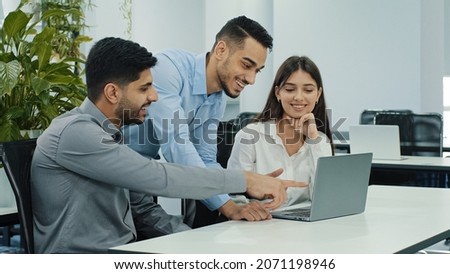 Friendly creative diverse colleagues team discuss online project use computer at workplace, multiracial coworkers group talk work together share ideas on digital marketing strategy at office meeting Royalty-Free Stock Photo #2071198946