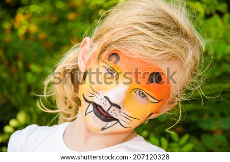 beautiful blond girl with tiger face painting