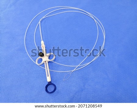 Closeup Image Of Endoscopic Instrument Polypectomy Snare In Blue Background. Selective Focus Royalty-Free Stock Photo #2071208549