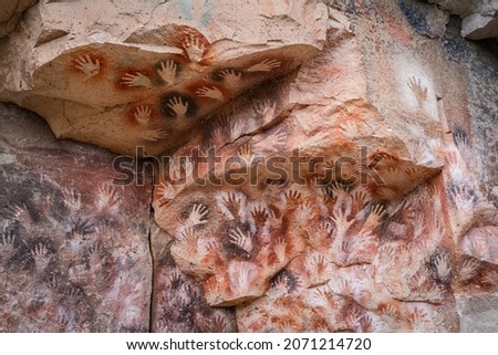 Prehistoric hand paintings at the Cave of the Hands (Spanish: Cueva de Las Manos ) in Santa Cruz Province, Patagonia, Argentina. The art in the cave dates from 13,000 to 9,000 years ago.