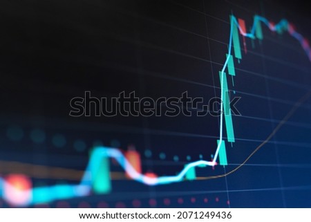 Closeup financial chart with uptrend line candlestick graph in stock market on monitor background Royalty-Free Stock Photo #2071249436
