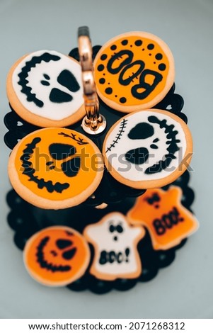 halloween themed cookies set up on a plain background