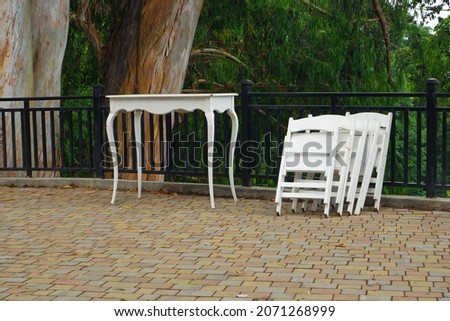 white wooden table and chair on the street