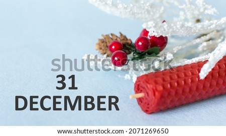 Vintage idea shows 31 December, end of year, light blue background with candle and holiday decor