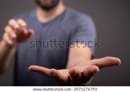 A male hand pointing on a blurred background