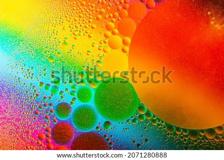 Macro photography of the oil drops on the water surface.Cosmic circles looks like molecule structure.Backdrop with copy space,good as template.