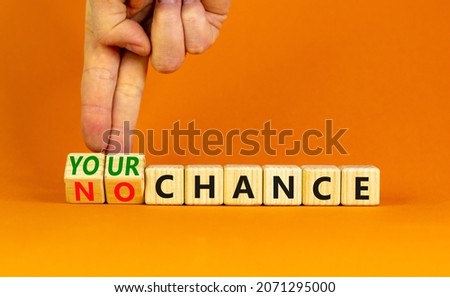 Your or my chance symbol. Businessman turns wooden cubes and changes words 'my chance' to 'your chance'. Beautiful orange background, copy space. Business and your or my chance concept.