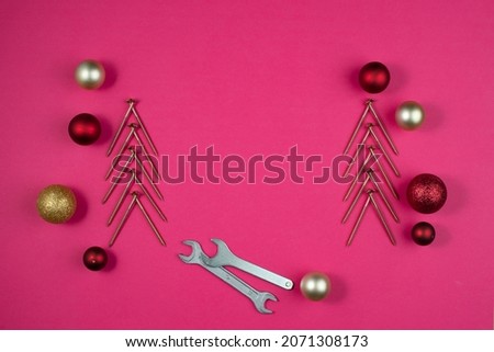 Industrial Christmas frame made of nails, wrench and Christmas balls.