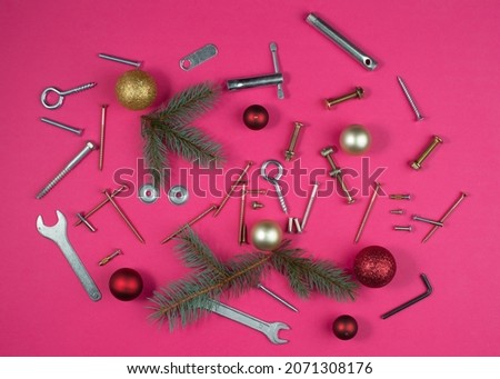 Industrial Christmas composition with mechanic tools, twigs and Christmas balls.