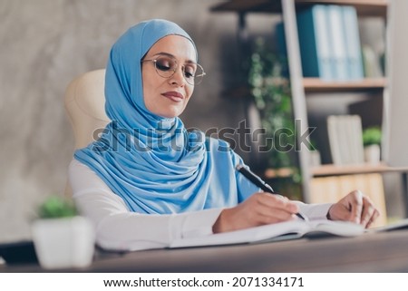 Profile side photo of young arab lady write pen task for week marketer remote work career occupation indoors
