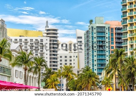 Miami South Beach Ocean Drive road street with famous retro art deco hotel colorful buildings cityscape with palm trees and blue sky on sunny day Royalty-Free Stock Photo #2071345790