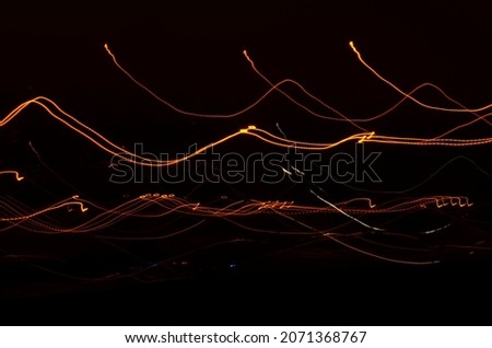 City lights in the form of lines and shot with slow shutter speeds at dusk. Can be used as background.