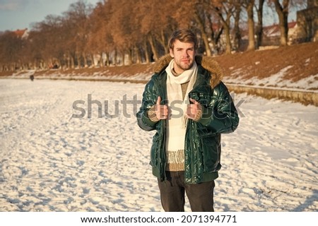 Explore. male in down coat with fur hood. feel warm and comfortable. favorite season. guy green puffer coat. man enjoy winter landscape. nature is beautiful. place for thoughts. cold and loneliness Royalty-Free Stock Photo #2071394771
