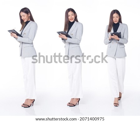 Collage Group Full length Figure snap of 20s Asian Woman brown hair business suit pant and high heels shoes. Female stands hold digital tablet check work social media over white Background isolated Royalty-Free Stock Photo #2071400975