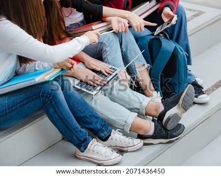 Group of four young attractive asian girls college students studying together in university campus outdoor. Concept for education, friendship and college students life. Royalty-Free Stock Photo #2071436450