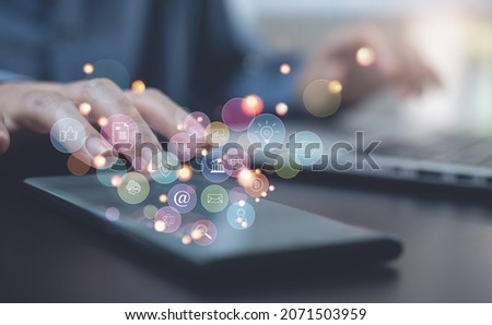 Internet of Things IoT, digital marketing, online shopping concept, Woman using mobile smart phone and laptop with internet network connection, social media, technology icons on virtual screen Royalty-Free Stock Photo #2071503959