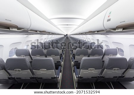 Typical interior of commercial passenger airplane Airbus A320 Royalty-Free Stock Photo #2071532594