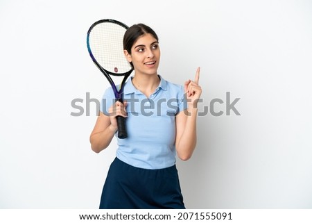 Handsome young tennis player caucasian woman isolated on white background pointing up a great idea
