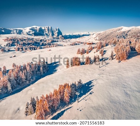 View from flying drone of Alpe di Siusi village. Amazing morning view of Dolomite Alps. Bright winter scene of ski resort, Ityaly, Europe. Active tourism concept background.