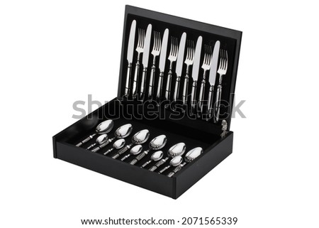 Set of silver cutlery in the box on an isolated white background. Gift wrapped forks, knives and spoons Royalty-Free Stock Photo #2071565339