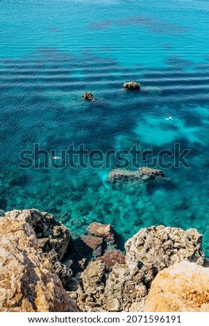 Two people snorkling in turquoise Mediterranean Sea,Malta.Aerial view of swimming people.Relax vacation concept.Crystal clear ocean.Snorkeler explores reefs.Malta beach top view.Active summer holiday Royalty-Free Stock Photo #2071596191