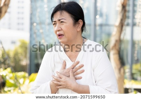 sick old senior woman suffering from GERD or acid reflux Royalty-Free Stock Photo #2071599650