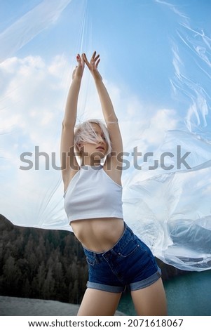 Perfect blonde woman short hair. Fashion woman poses in summer in nature on a sunny day. Red nail manicure