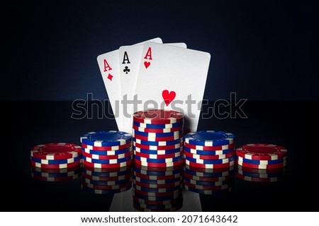 Poker game with three of kind or set combination. Chips and cards on table. Successful and win three aces
