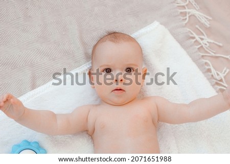 the baby is lying on the bed top view 