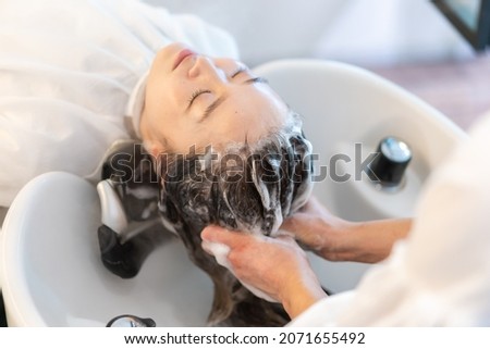 A woman at a hair salon Royalty-Free Stock Photo #2071655492