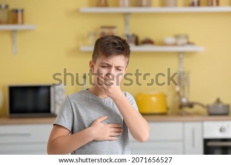 Coughing little boy at home Royalty-Free Stock Photo #2071656527