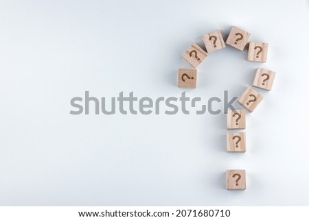 Wooden blocks in shape of question mark on gray background. with copy space