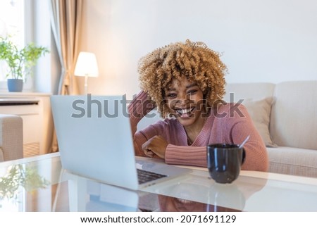 Image of young pleased happy cheerful cute beautiful business woman sit indoors at home using laptop computer. Beautiful young woman working on her laptop in her office. Royalty-Free Stock Photo #2071691129