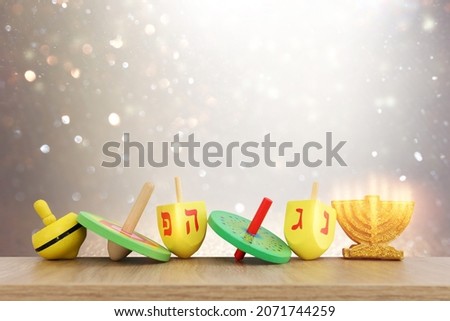 Image of jewish holiday Hanukkah with wooden dreidels collection (spinning top) over glitter background