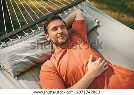 Man napping in hammock in nature