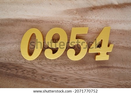 Golden Arabic numerals 0954 on a dark brown to white wood grain background.