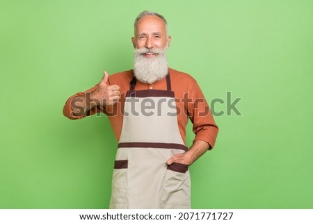 Photo of mature man show thumb-up great perfect service choice master isolated over green color background