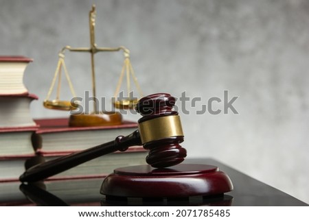 Legal Law and Justice concept - Open law book with a wooden judges gavel on table in a courtroom or law enforcement office. Copy space for text Royalty-Free Stock Photo #2071785485