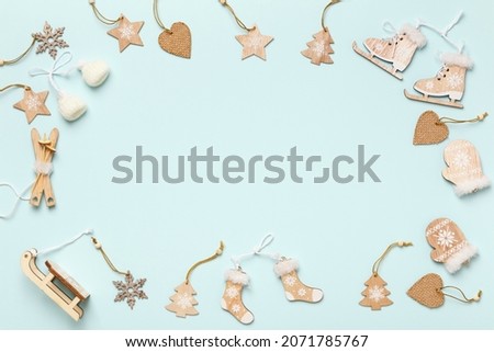 Frame from wooden Christmas tree decorations on a blue background. Copy space flat lay top view.