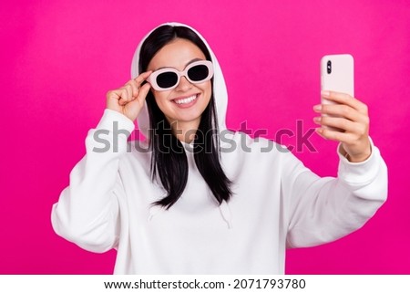 Photo of young pretty girl hand touch glasses shoot selfie smartphone isolated over magenta color background