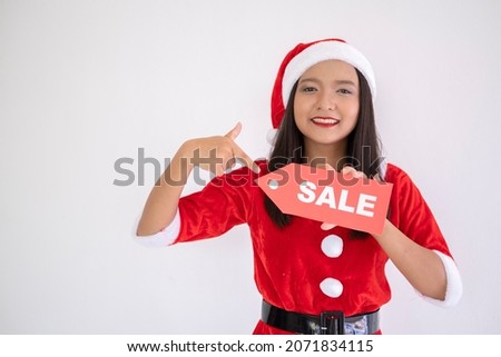 Santa claus girl holding a sign for sale,happy santa claus girl.