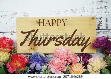 Happy Thursday text on wooden planks decoration with flower border frame