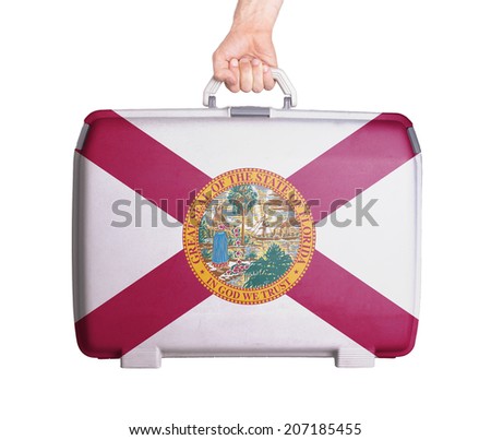 Used plastic suitcase with stains and scratches, printed with flag, Florida
