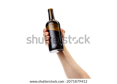 Whiskey, rum, cognac. Cropped image of male hand holding bottle of strong alcohol drink isolated over white background. Concept of alcohol, drink, party, degustation, holiday. Copy space for ad