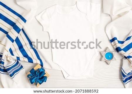 Jewish holiday Hanukkah white romper mockup with gift box and candles, Top view from above on white background. Flat lay, copy space.